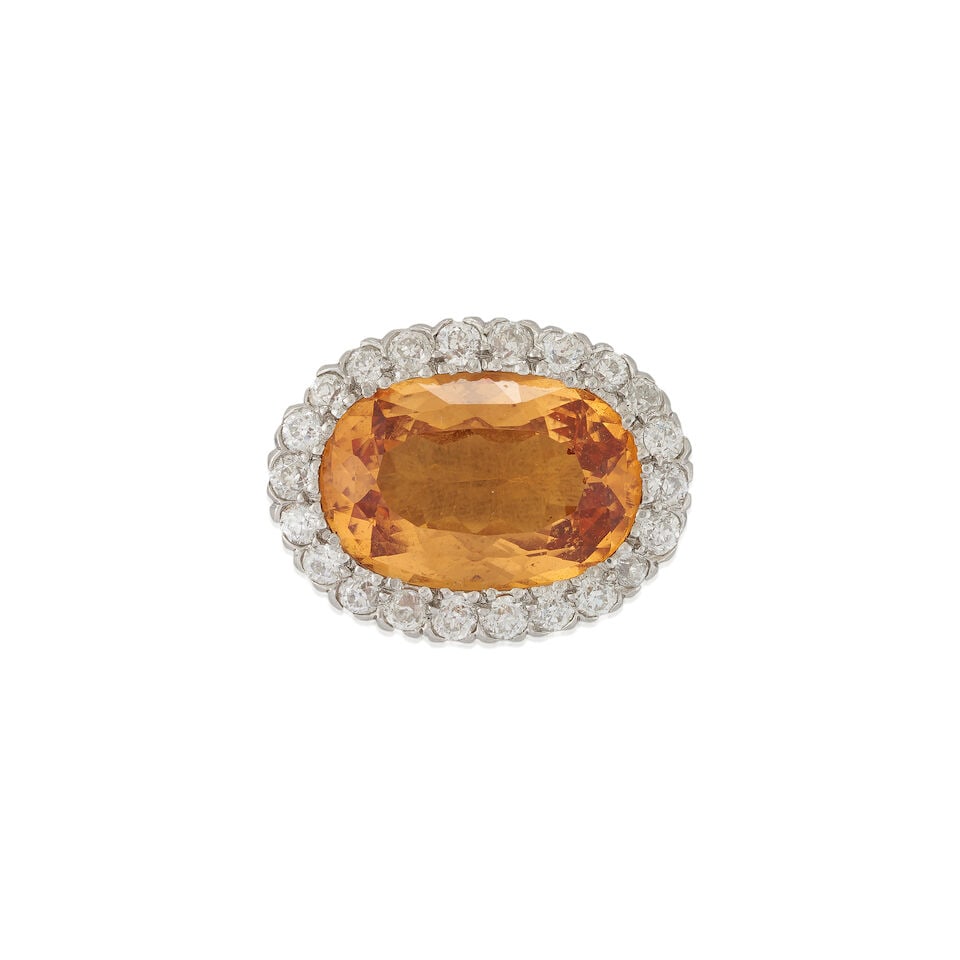 TIFFANY & CO.: AN ANTIQUE TOPAZ AND DIAMOND BROOCH: TIFFANY & CO.: AN ANTIQUE TOPAZ AND DIAMOND BROOCH Centering a fancy-cut topaz measuring approximately 17.00 x 11.50 x 7.10 mm, framed by old European-cut diamonds, approximate total diamond weight