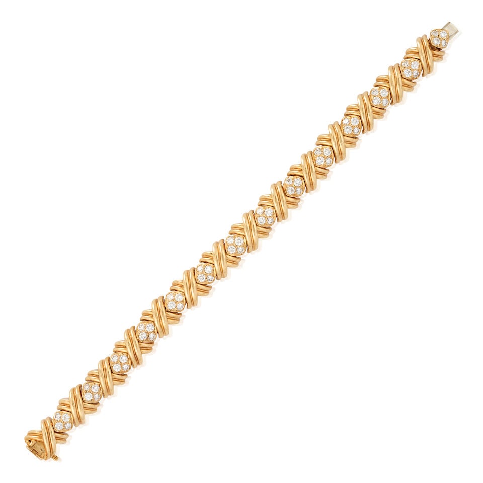TIFFANY & CO.: AN 18K GOLD AND DIAMOND 'SIGNATURE X' BRACELET: TIFFANY & CO.: AN 18K GOLD AND DIAMOND 'SIGNATURE X' BRACELET Composed of a series of 'X' and full-cut diamond links, approximate total diamond weight 3.65 carats, weight 32.3 dwt, signed T&Co.,