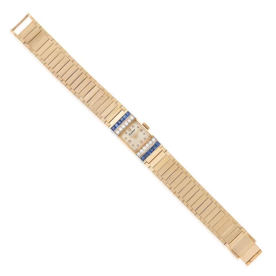 CARTIER: A 14K GOLD, SAPPHIRE, AND DIAMOND WRISTWATCH, CIRCA 1950: CARTIER: A 14K GOLD, SAPPHIRE, AND DIAMOND WRISTWATCH, CIRCA 1950 Enclosing a manual-wind, 17-jewel movement, bordered by full-cut diamonds and channel-set sapphires, gross weight 23.5 dwt, dial