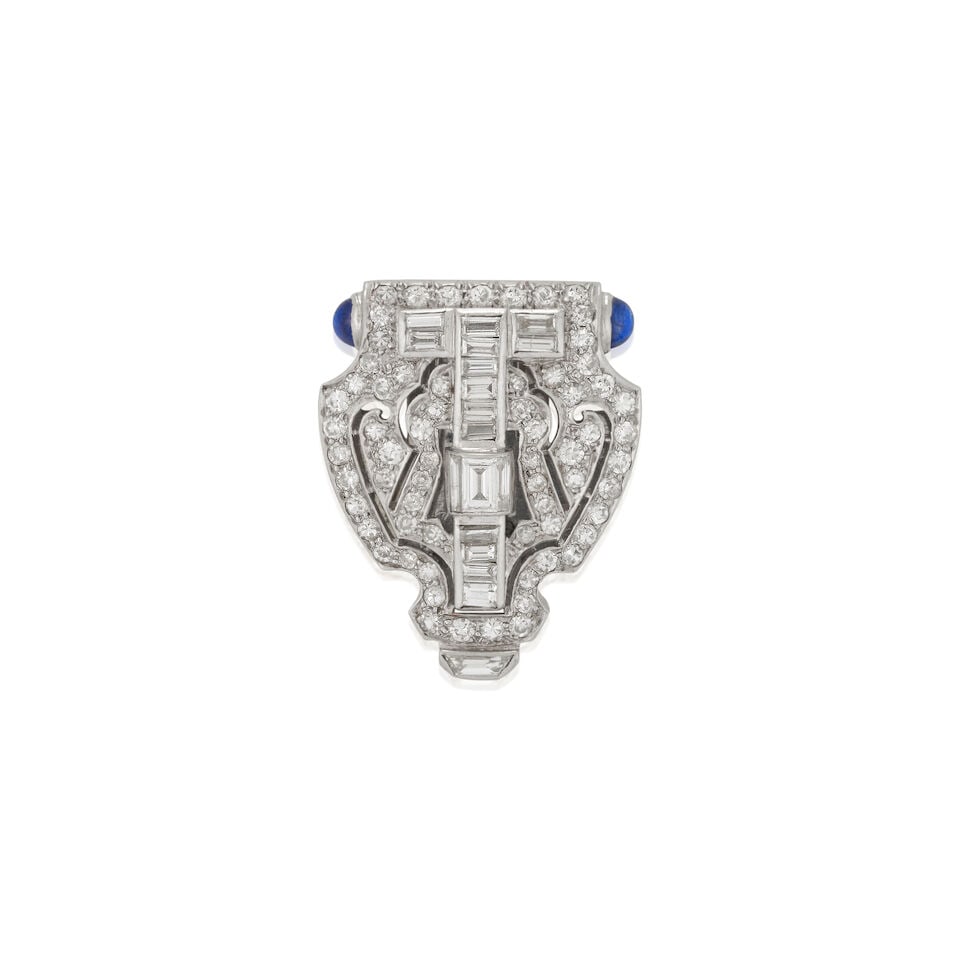 AN ART DECO PLATINUM, SAPPHIRE, AND DIAMOND DRESS CLIP: AN ART DECO PLATINUM, SAPPHIRE, AND DIAMOND DRESS CLIP Set with single and baguette-cut diamonds, approximate total weight 2.20 carats, with sapphire cabochon terminals, and engraved platinum accents,
