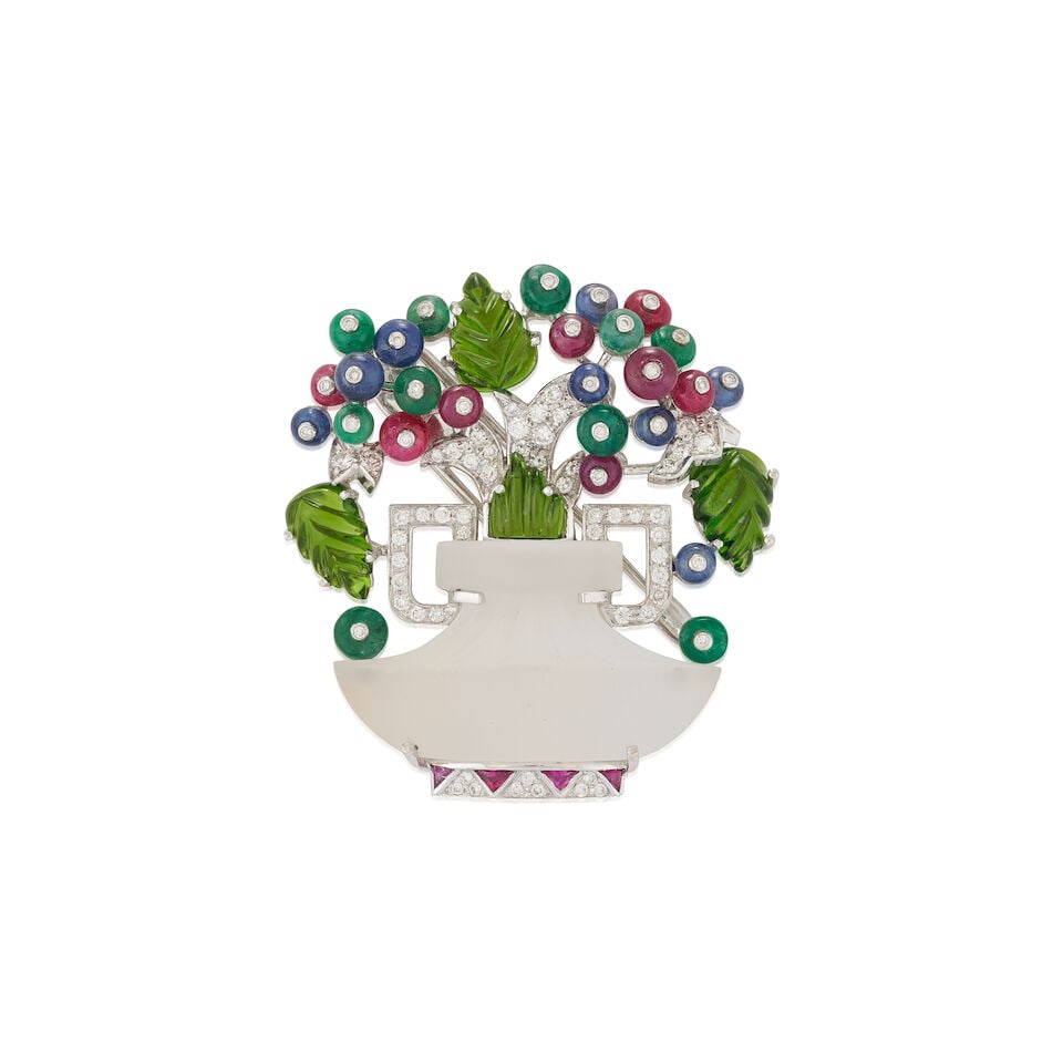 ROBERTO LEGNAZZI: A ROCK CRYSTAL, GEM-SET, AND DIAMOND GIARDINETTI BROOCH, ITALY: ROBERTO LEGNAZZI: A ROCK CRYSTAL, GEM-SET, AND DIAMOND GIARDINETTI BROOCH, ITALY Designed as a carved rock crystal flowerpot, with sapphire, ruby, and emerald bead flowers, carved peridot leaves, and