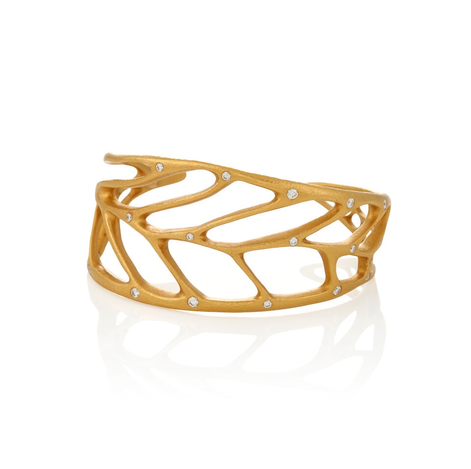 LINDA LEE JOHNSON: A HIGH KARAT GOLD AND DIAMOND 'LINDEN' LEAF CUFF: LINDA LEE JOHNSON: A HIGH KARAT GOLD AND DIAMOND 'LINDEN' LEAF CUFF Designed as a hammered gold stylized leaf, set with full-cut diamonds, weight 37.6 dwt, maker's mark for Linda Lee Johnson, 