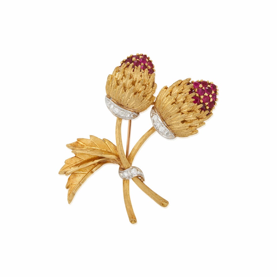 AN 18K GOLD, RUBY, AND DIAMOND THISTLE BROOCH: AN 18K GOLD, RUBY, AND DIAMOND THISTLE BROOCH The circular-cut ruby thistles, with full-cut diamond accents, weight 14.4 dwt, length 2 in. For further information on this lot please visit