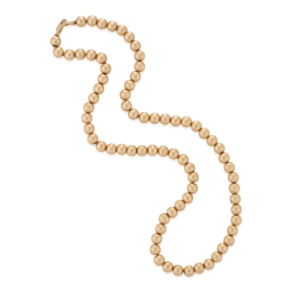 A 14K GOLD BEAD NECKLACE: A 14K GOLD BEAD NECKLACE Composed of textured gold beads, each measuring approximately 7.90 mm, weight 22.3 dwt, length 2 1/2 in. For further information on this lot please visit Bonhams.com For fur