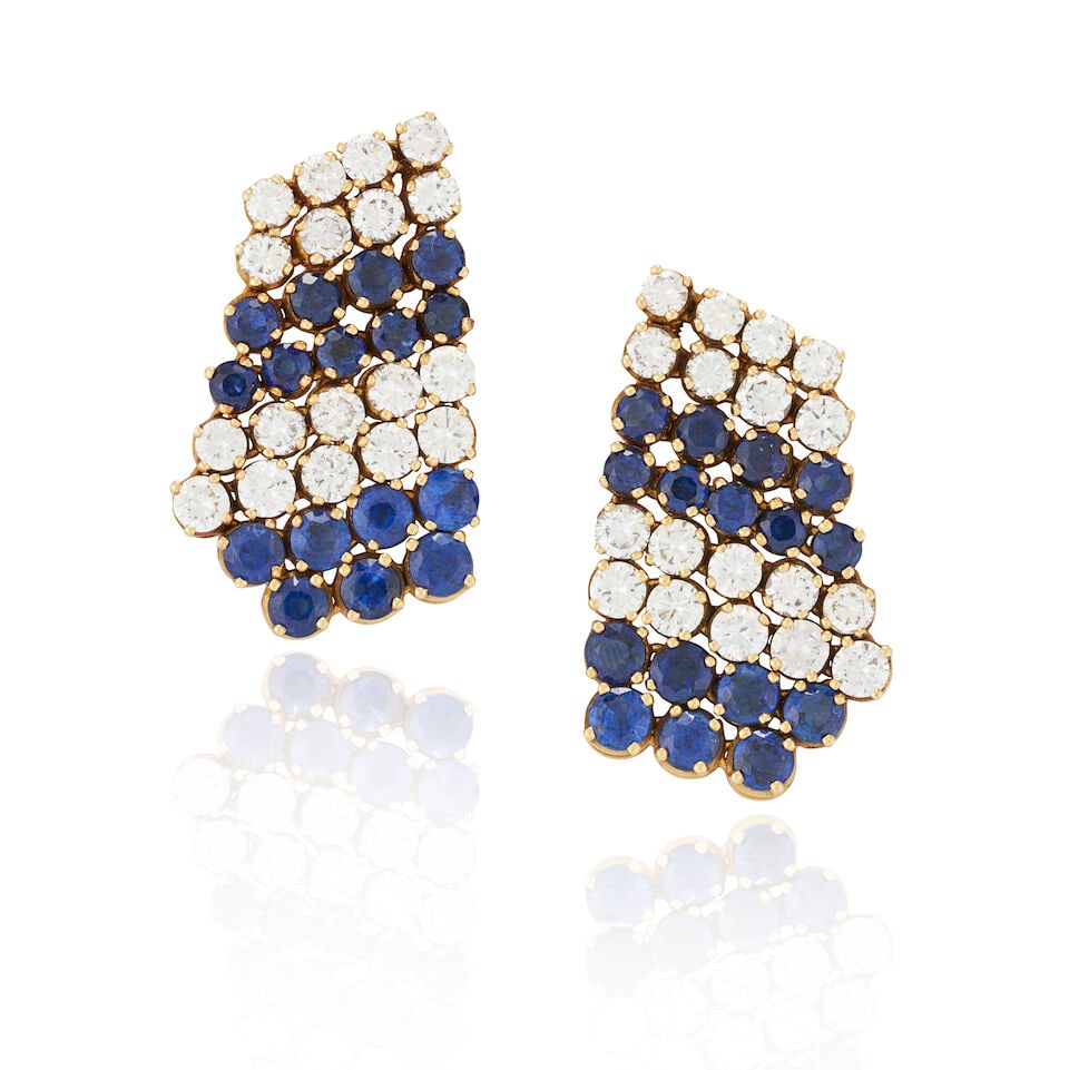 A PAIR OF 18K GOLD, SAPPHIRE, AND DIAMOND EARCLIPS: A PAIR OF 18K GOLD, SAPPHIRE, AND DIAMOND EARCLIPS The flexible clips set with full-cut diamonds, approximate total weight 4.80 carats, and circular-cut sapphires, weight 11.6 dwt, the backs with
