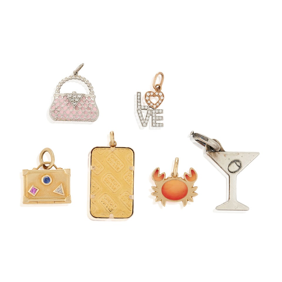 TIFFANY & CO.: A GROUP OF FIVE CHARMS: TIFFANY & CO.: A GROUP OF FIVE CHARMS Comprising three 18k gold charms, including a gem-set suitcase, a crab, and a love charm set with full-cut diamonds, and a platinum purse charm with full-cut