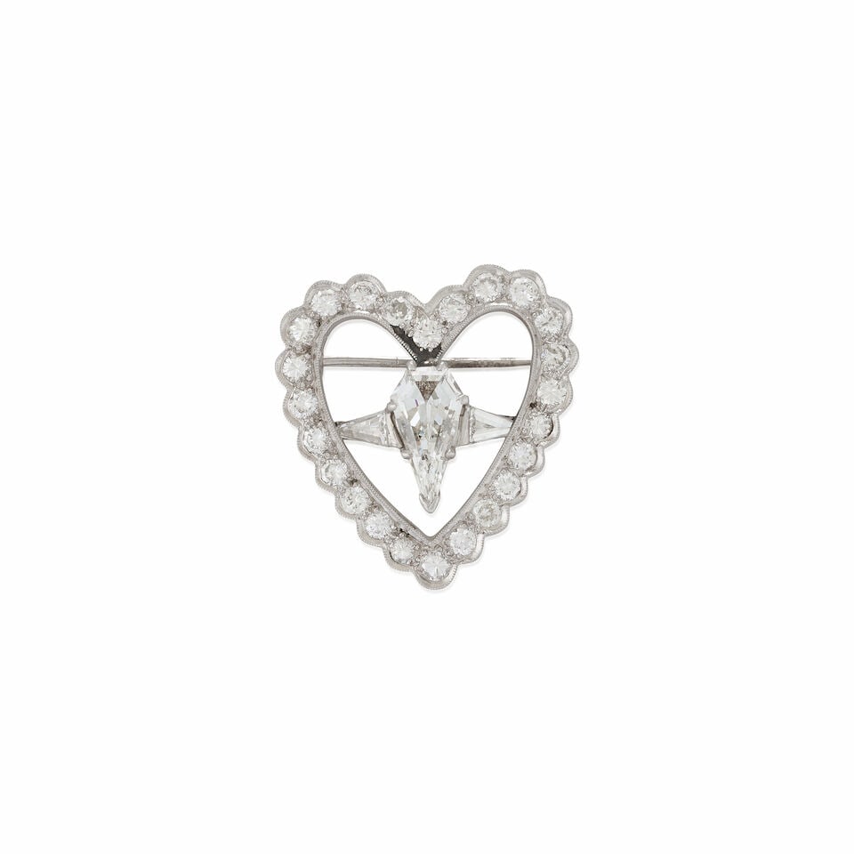 A PLATINUM AND DIAMOND PENDANT/BROOCH: A PLATINUM AND DIAMOND PENDANT/BROOCH Designed as a heart, set with full and transitional-cut diamonds, approximate total weight 1.20 carats, and centering a fancy-cut calf's head diamond, weighing