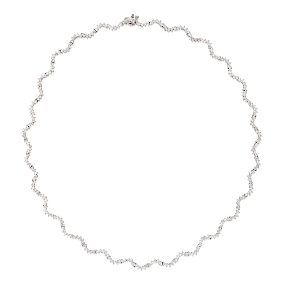 A 14K WHITE GOLD AND DIAMOND NECKLACE: A 14K WHITE GOLD AND DIAMOND NECKLACE Composed of curved links set with full-cut diamonds, manufacturer's stated weight of 7.45 carats, weight 17.5 dwt, length 19 in. For further information on