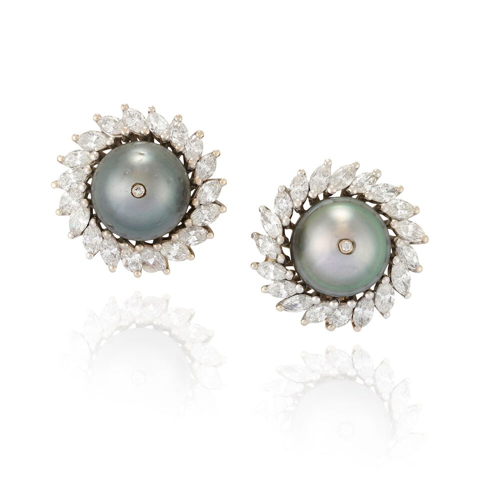 A PAIR OF 14K WHITE GOLD, TAHITIAN PEARL, AND DIAMOND EARCLIPS: A PAIR OF 14K WHITE GOLD, TAHITIAN PEARL, AND DIAMOND EARCLIPS Each centering a Tahitian pearl measuring approximately 12.10 mm, and set with a full-cut diamond, framed by marquise-cut diamonds,