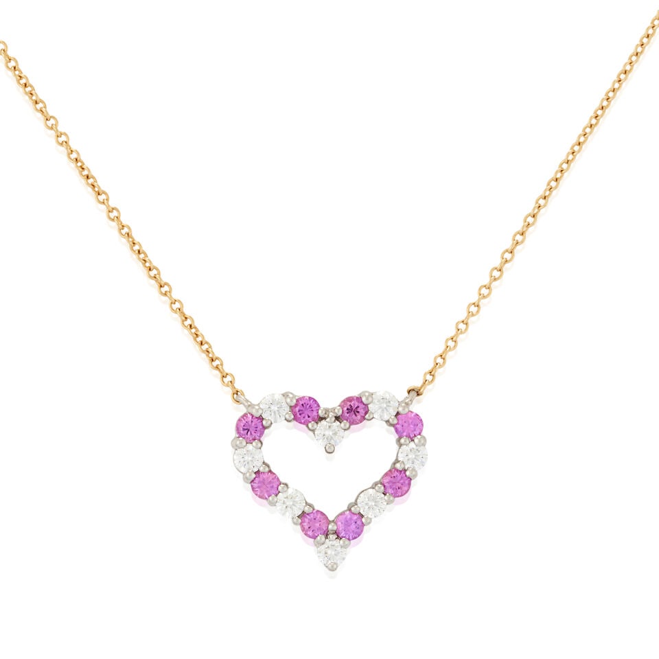 TIFFANY & CO.: A PINK SAPPHIRE AND DIAMOND HEART PENDANT NECKLACE: TIFFANY & CO.: A PINK SAPPHIRE AND DIAMOND HEART PENDANT NECKLACE The pendant designed as a heart, set with circular-cut pink sapphires and full-cut diamonds, set in platinum, and joined to an 18k gol