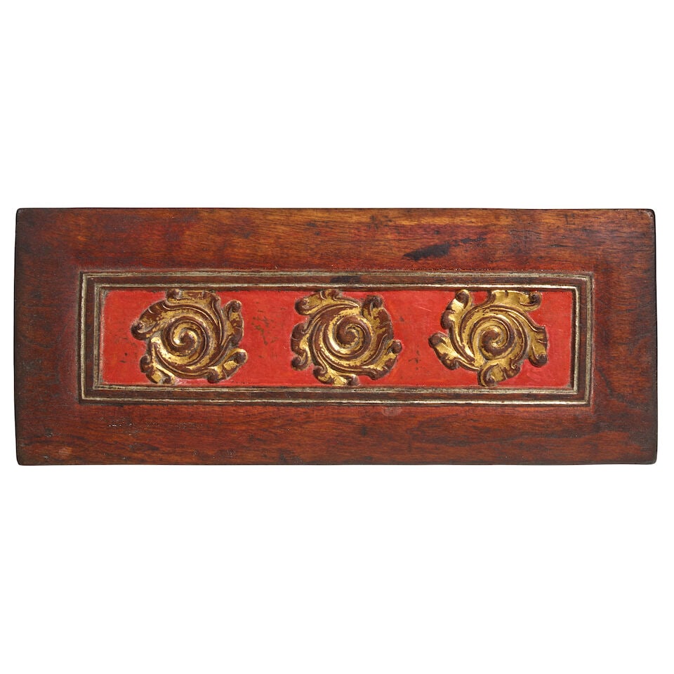 A GILT LACQUER POLYCHROMED WOOD MANUSCRIPT COVER TIBET, CIRCA 14TH CENTURY: A GILT LACQUER POLYCHROMED WOOD MANUSCRIPT COVER TIBET, CIRCA 14TH CENTURY One side carved with a kirtimukha flanked by foliate scrolls; Himalayan Art Resources item no. 8817 13 5/8 x 5 1/2 in.