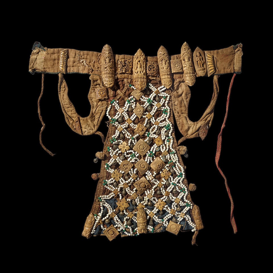 A NECROMANCERS BONE APRON TIBET OR NEPAL, 16TH/17TH CENTURY: A NECROMANCERS BONE APRON TIBET OR NEPAL, 16TH/17TH CENTURY Bone, glass beads, metal bells, and cloth. Himalayan Art Resources item no. 8814 22 1/2 x 24 in. (57.1 x 61