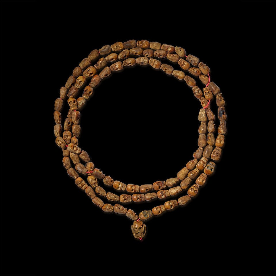 A MONUMENTAL CARVED BONE MALA WITH 108 SKULL-SHAPED BEADS TIBET, 19TH CENTURY OR EARLIER: A MONUMENTAL CARVED BONE MALA WITH 108 SKULL-SHAPED BEADS TIBET, 19TH CENTURY OR EARLIER Bone strung on modern thread Himalayan Art Resources item no. 8807 Overall: 181 1/2 in. (461 cm) long; Master b