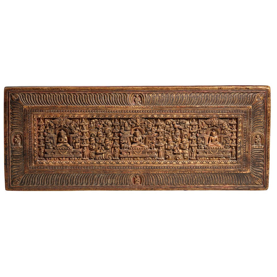 A GILT AND POLYCHROME WOOD MANUSCRIPT COVER TIBET, 14TH/ 15TH CENTURY: A GILT AND POLYCHROME WOOD MANUSCRIPT COVER TIBET, 14TH/ 15TH CENTURY Himalayan Art Resources item no. 90372 10 1/2 x 26 3/4 in. (26.7 x 67.9 cm) Footnotes: 西藏