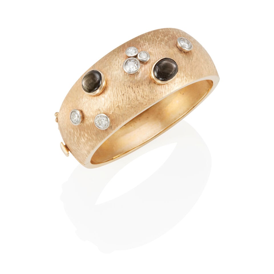 14K GOLD, STAR SAPPHIRE, AND DIAMOND BRACELET: 14K GOLD, STAR SAPPHIRE, AND DIAMOND BRACELET • 14k yellow and white gold • 6 round diamonds weighing approximately 1.85 - 1.95 carat total • 2 cabochon star sapphires weighing