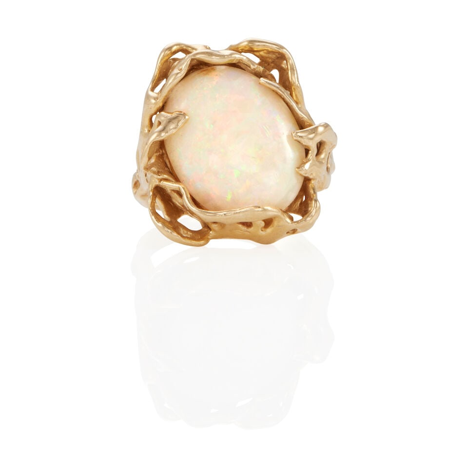14K GOLD AND OPAL RING: 14K GOLD AND OPAL RING • 14k yellow gold • 1 oval cabochon opal weighing approximately 3.65 - 3.70 carats total (14.49 x 12.68 x 3.89 mm) • Size: 4 ¼ • Estimated gross wei