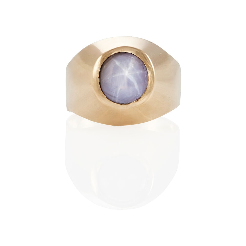 14K GOLD AND STAR SAPPHIRE RING: 14K GOLD AND STAR SAPPHIRE RING • 14k yellow gold • 1 oval cabochon star sapphire weighing approximately 6.69 carats (9.10 x 8.60 x 8.10 mm) • Size: 10 ¾ • Estimated gross