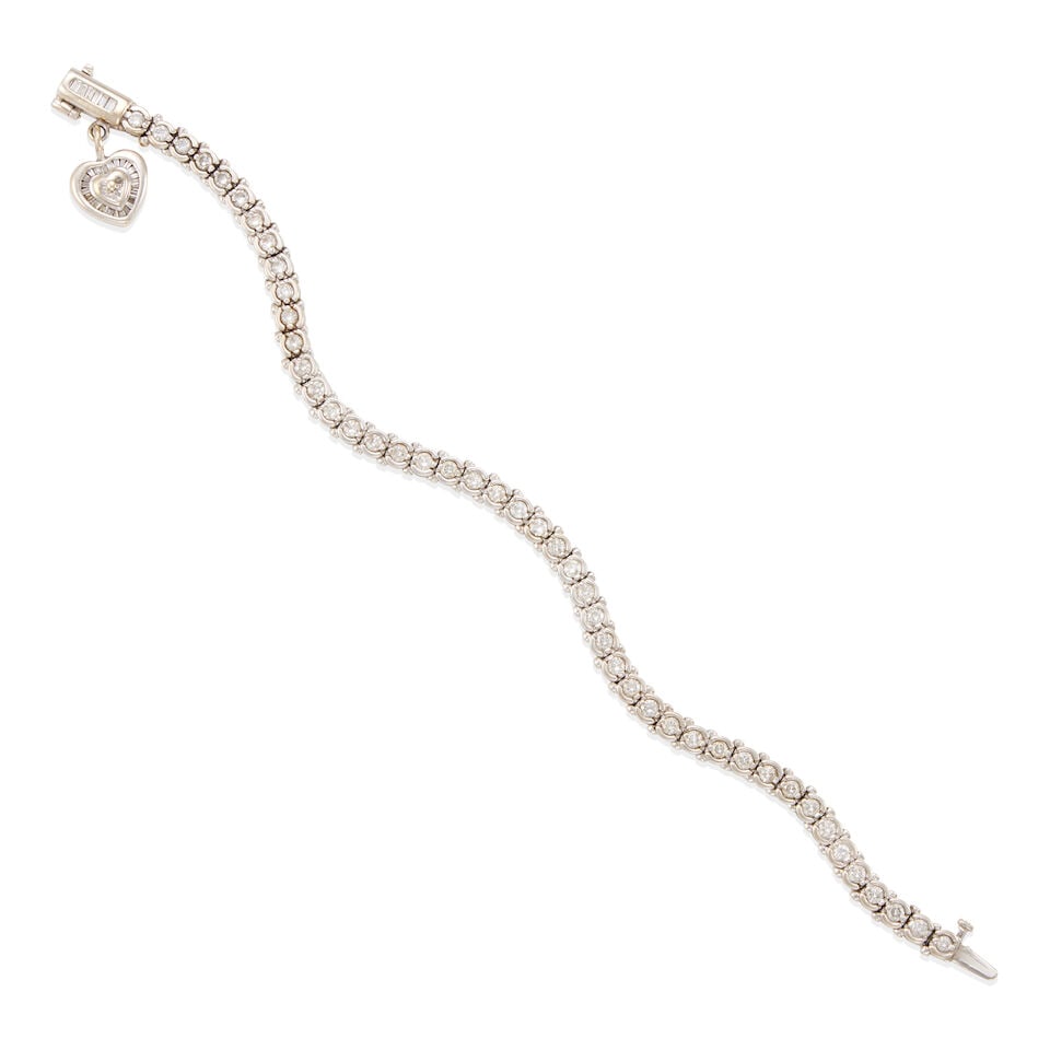 14K WHITE GOLD AND DIAMOND STRAIGHT-LINE BRACELET WITH CHARM: 14K WHITE GOLD AND DIAMOND STRAIGHT-LINE BRACELET WITH CHARM • 14k white gold • Numerous round and baguette diamonds weighing approximately 2.70 - 2.75 carats total • Length: 7