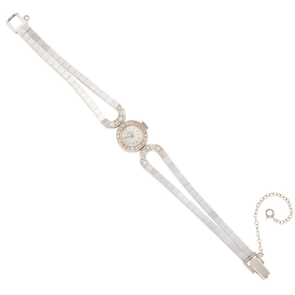 MOVIGA: 14K WHITE GOLD AND DIAMOND RETRO ERA WRISTWATCH: MOVIGA: 14K WHITE GOLD AND DIAMOND RETRO ERA WRISTWATCH • 14k white gold • Numerous round single diamonds weighing approximately 0.40 - 0.45 carats total • Signed 'MOVIGA MH' on