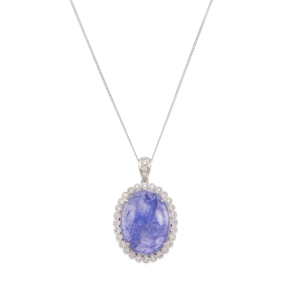PLATINUM, WHITE GOLD, TANZANITE, AND DIAMOND PENDANT NECKLACE: PLATINUM, WHITE GOLD, TANZANITE, AND DIAMOND PENDANT NECKLACE • 950 platinum pendant, 9k white gold chain • 1 oval shape cabochon tanzanite weighing approximately 12.10 - 12.15 carats