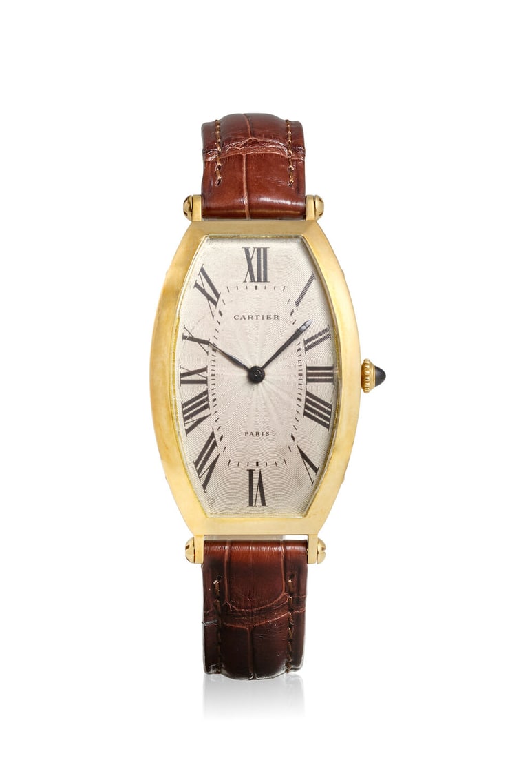 CARTIER. AN 18K GOLD MANUAL WIND WRISTWATCH Tonneau, c. 1990s (1 of 3)