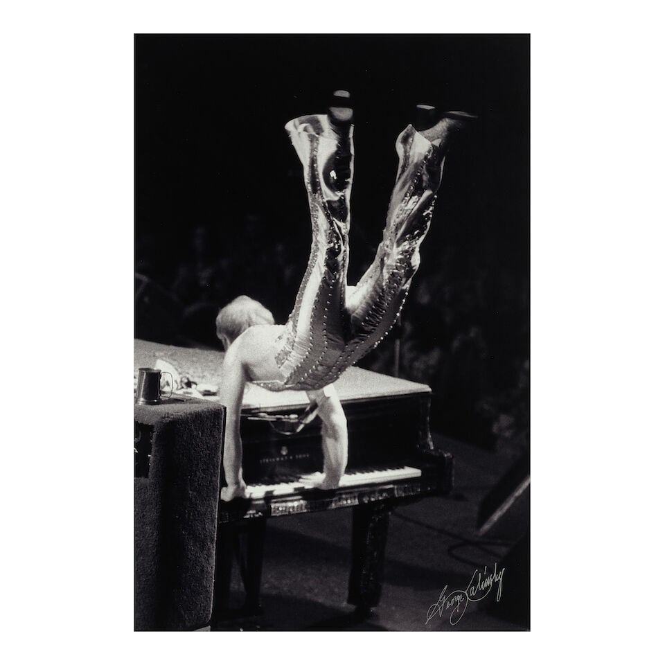 George Kalinsky (1936-2025): Sir Elton John[Madison Square Garden, November 1974]: George Kalinsky (1936-2025): Sir Elton John [Madison Square Garden, November 1974] signed George Kalinsky (lower right) black and white photograph sight 17 1/2 x 11 5/8in; framed 28 1/4 x 19 1/4in Foo