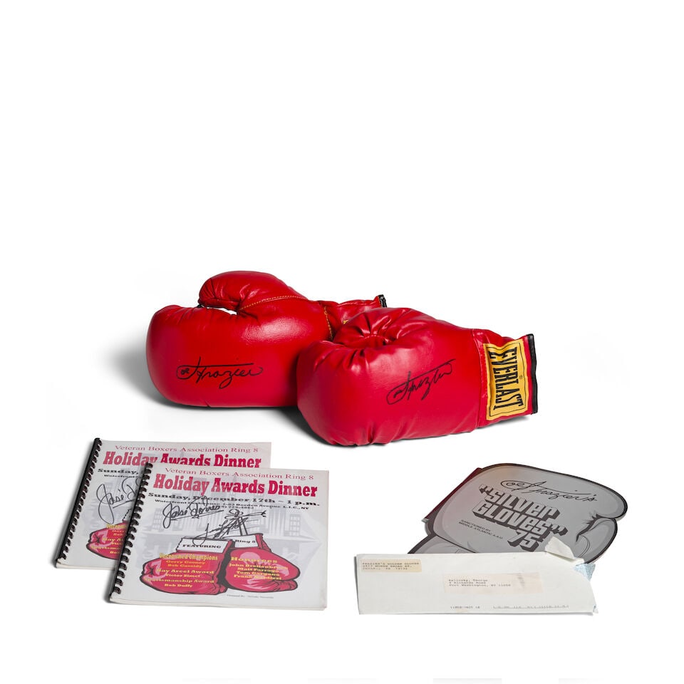 A Pair of Boxing Gloves Signed by Joe Frazier: A Pair of Boxing Gloves Signed by Joe Frazier each signed Joe Frazier, one glove length 12 1/2in; width 7in; the other glove length 12in; width 6 1/2in. Together with two copies of the Veteran Boxers