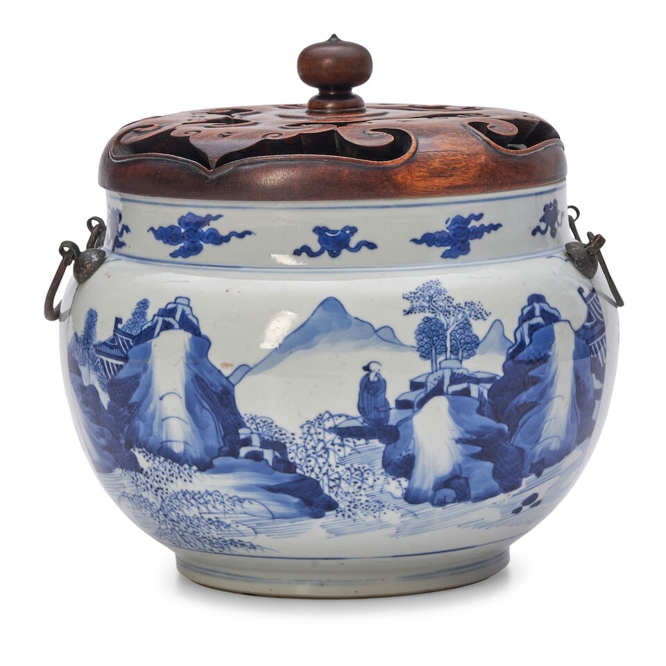 A BLUE AND WHITE POT WITH CARVED WOOD COVER Kangxi: A BLUE AND WHITE POT WITH CARVED WOOD COVER Kangxi 9 1/4in (23.5cm) high Footnotes: 清康熙 青花山水人物圖罐