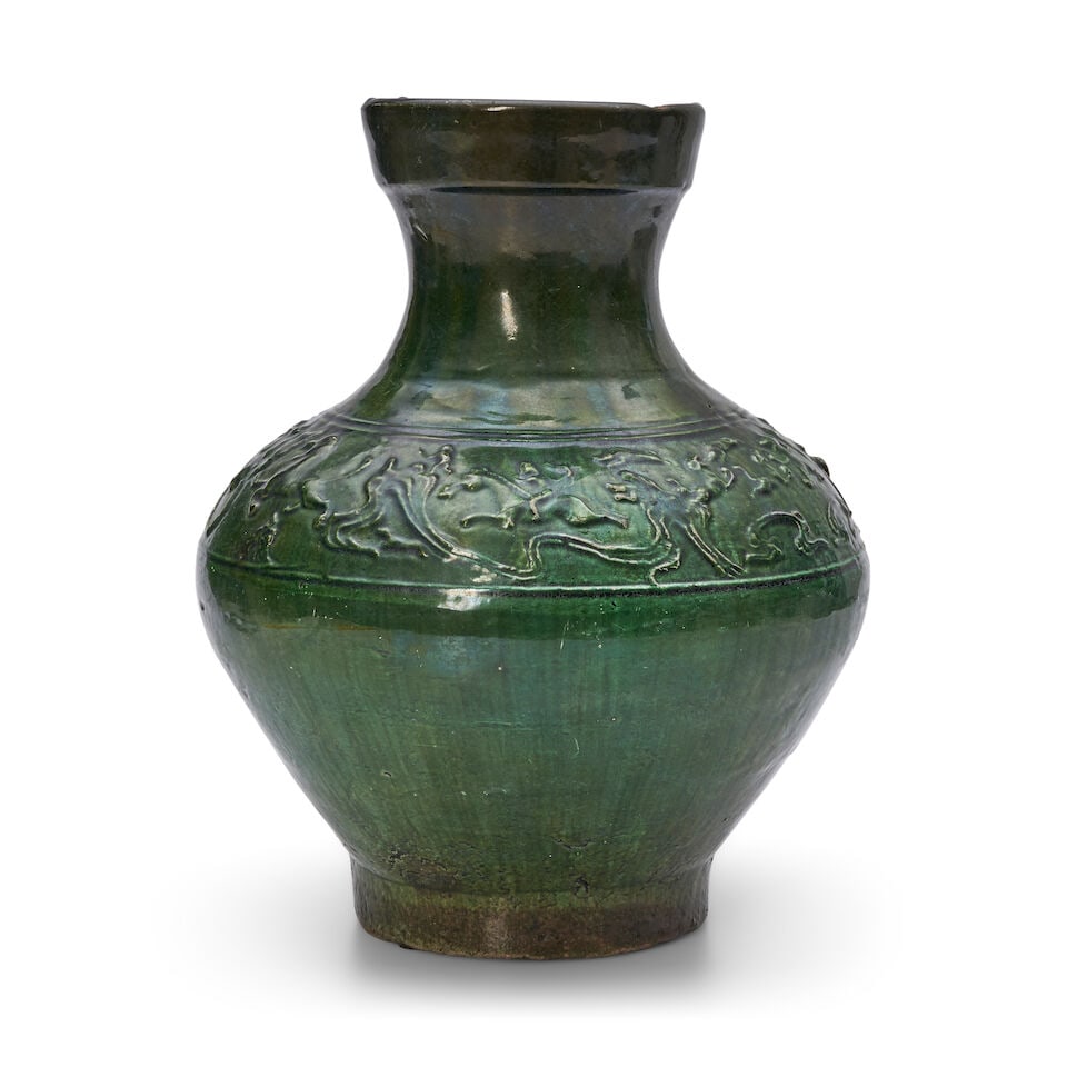 A GREEN-GLAZED MOULDED POTTERY JAR, HU Han Dynasty: A GREEN-GLAZED MOULDED POTTERY JAR, HU Han Dynasty 13 3/4in (34.9cm) high Footnotes: 漢 綠釉模印鋪首耳陶壺 Provenance: J.J. Lally & Co.,