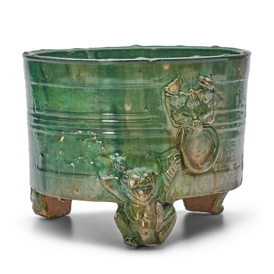 A GREEN-GLAZED POTTERY CYLINDRICAL TRIPOD VESSEL, LIAN Han Dynasty (1 of 2)