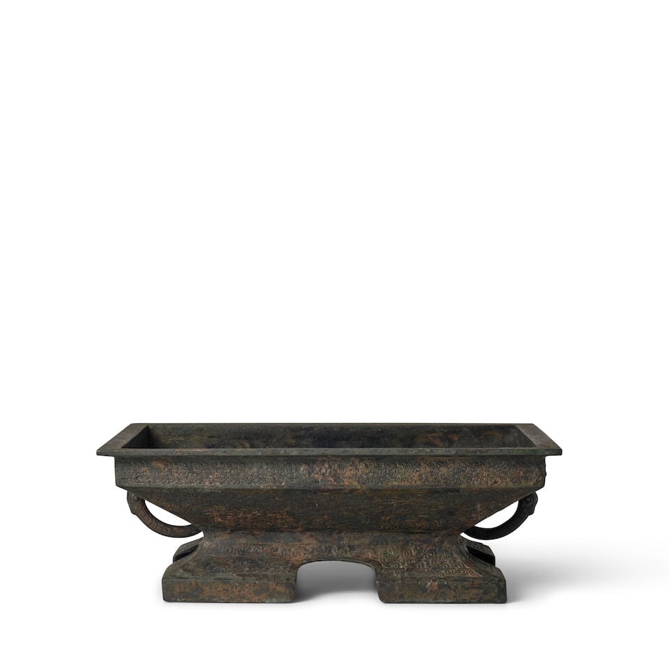 AN ARCHAIC BRONZE FOOD VESSEL, FU Spring and Autumn period, 6th century BC (fitted wood stand): AN ARCHAIC BRONZE FOOD VESSEL, FU Spring and Autumn period, 6th century BC 12 15/16in (32.8cm) across; 4 1/2in (11.4cm) high (fitted wood stand). Footnotes: 春秋 青铜簠
