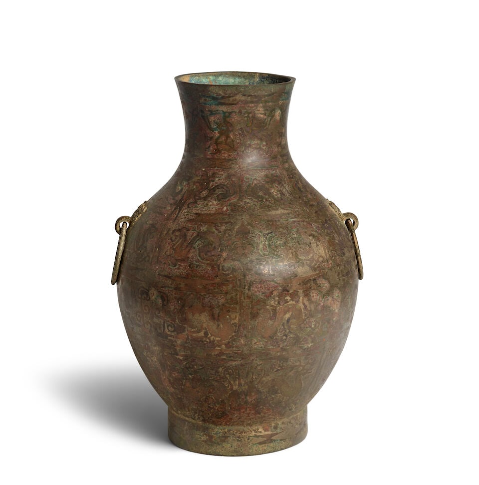A COPPER-INLAID BRONZE WINE VESSEL WITH LOOSE TAOTIE RING HANDLES Warring States period: A COPPER-INLAID BRONZE WINE VESSEL WITH LOOSE TAOTIE RING HANDLES Warring States period 14 1/2in (37cm) high Footnotes: 戰國