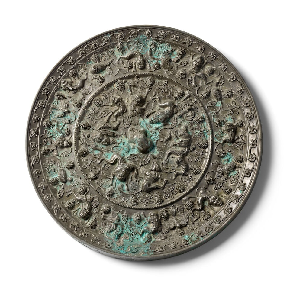 A LARGE TANG-STYLE 'LION AND GRAPEVINE' BRONZE MIRROR (1 of 2)