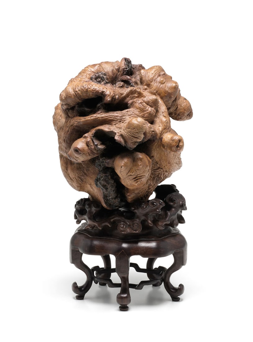 A BURLWOOD 'SCHOLAR'S ROCK' (wood stand): A BURLWOOD 'SCHOLAR'S ROCK' 6 3/4in (17.2cm) high (wood stand). Footnotes: 癭木隨形仿賞石 For further information on this lot please visit Bonhams.com For fu