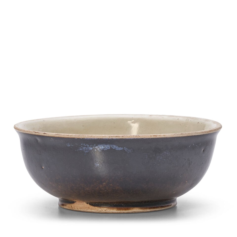 A SMALL HENAN BLACK AND CREAM-GLAZED DEEP BOWL Tang Dynasty (1 of 2)