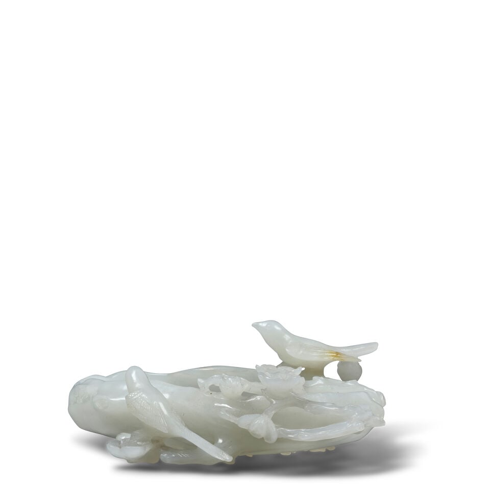 A WHITE JADE 'PRUNUS AND MAGPIE' WATER COUPE Late Qing Dynasty: A WHITE JADE 'PRUNUS AND MAGPIE' WATER COUPE Late Qing Dynasty 5in (12.7cm) across Footnotes: 清晚期 「喜上眉梢」白玉洗 Provenan