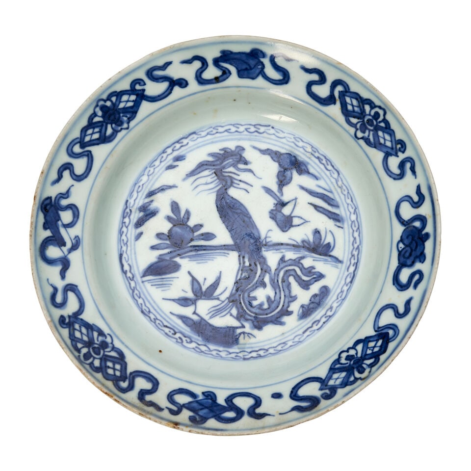 A BLUE AND WHITE 'PHOENIX' PLATE Jiajing: A BLUE AND WHITE 'PHOENIX' PLATE Jiajing 7 5/8in (19.4cm) diam Footnotes: 明嘉靖 青花鳳鳥紋盤 Please note this Lot is to be sold at No Reserve.
