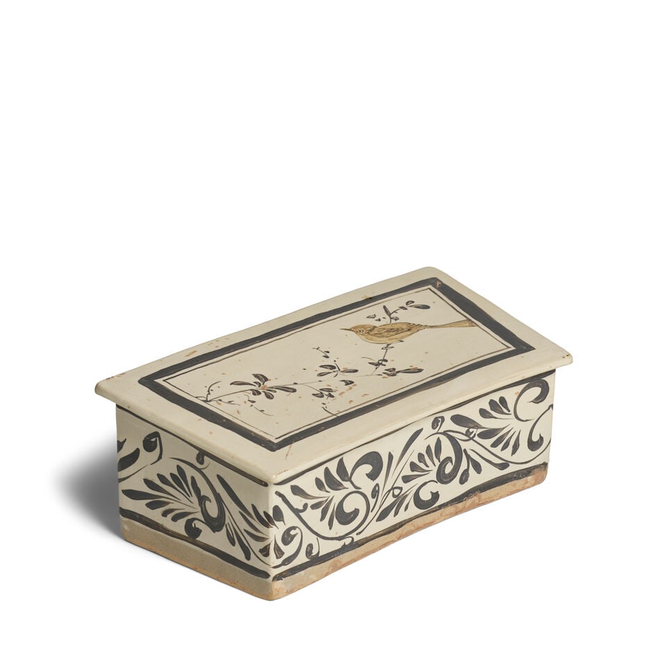 A CIZHOU BLACK-PAINTED 'BIRD AND FLOWER' RECTANGULAR PILLOW Song Dynasty: A CIZHOU BLACK-PAINTED 'BIRD AND FLOWER' RECTANGULAR PILLOW Song Dynasty 11 1/4in (28.6cm) across Footnotes: 宋