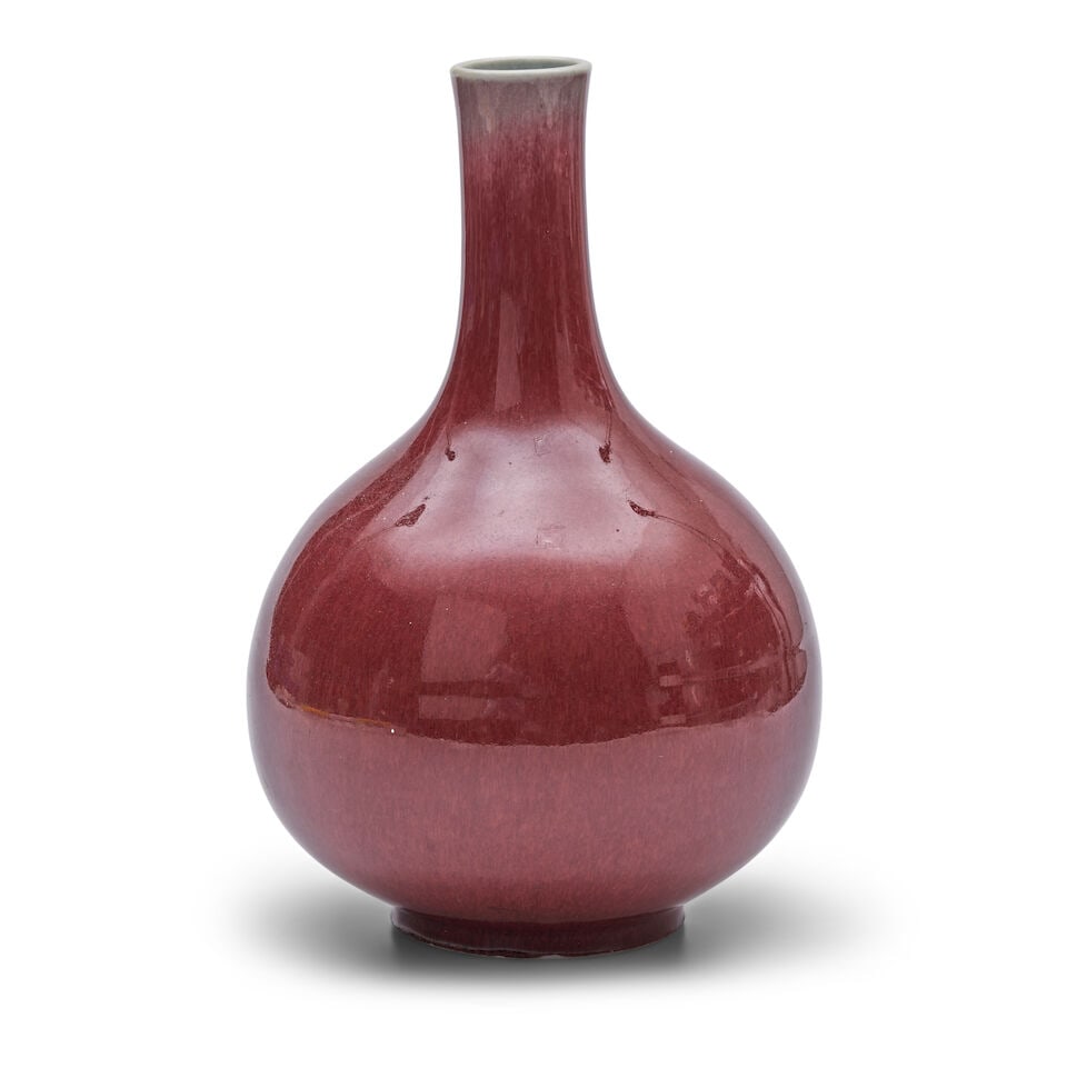 A COPPER-RED-GLAZED BOTTLE VASE Qing Dynasty: A COPPER-RED-GLAZED BOTTLE VASE Qing Dynasty 11 1/4in (28.6cm) high Footnotes: 清 紅釉瓶 For further information on this lot please visit Bonhams.com For further information ab