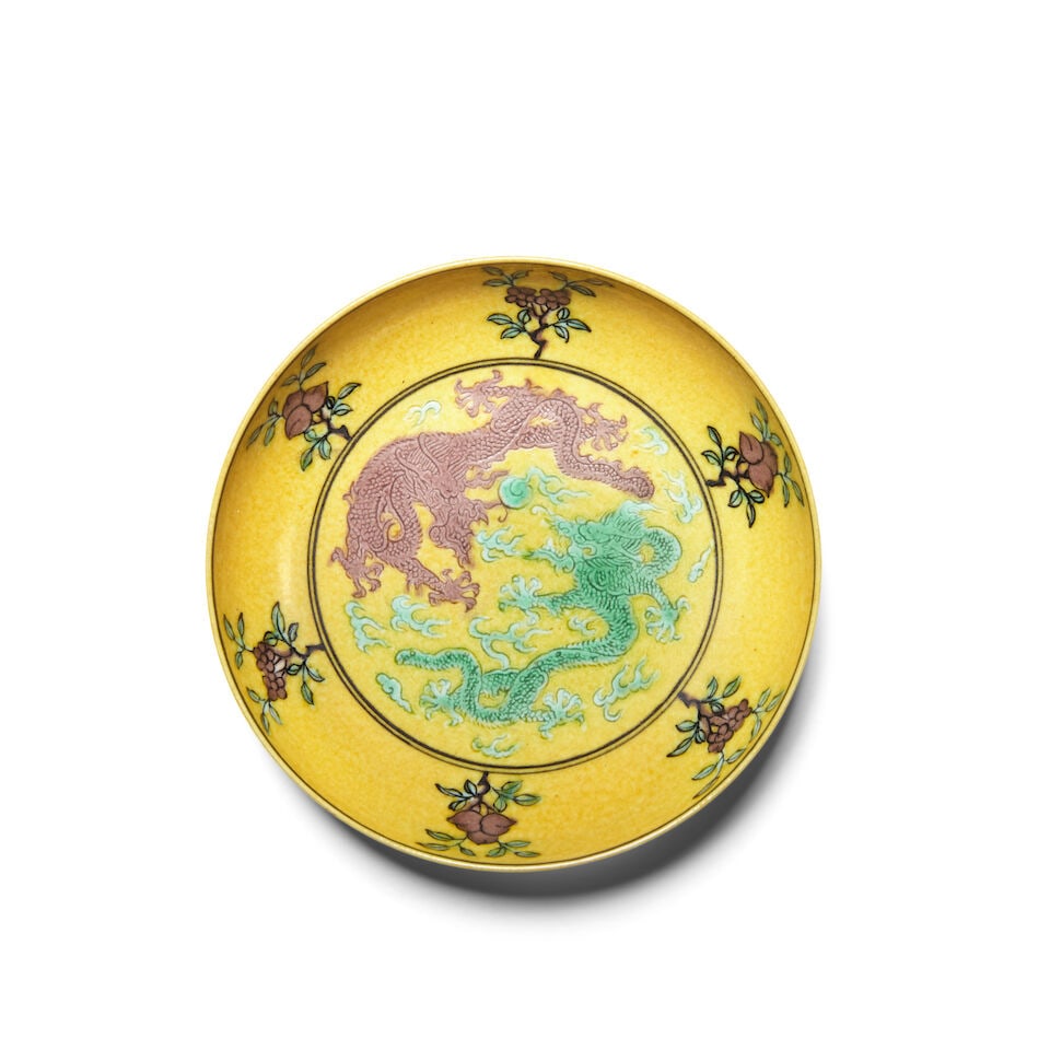 A YELLOW-GROUND AUBERGINE AND GREEN-ENAMELED 'DRAGON' SAUCER DISH Qianlong six-character mark: A YELLOW-GROUND AUBERGINE AND GREEN-ENAMELED 'DRAGON' SAUCER DISH Qianlong six-character mark 4 1/4in (10.7cm) diam Footnotes: 乾隆六字款