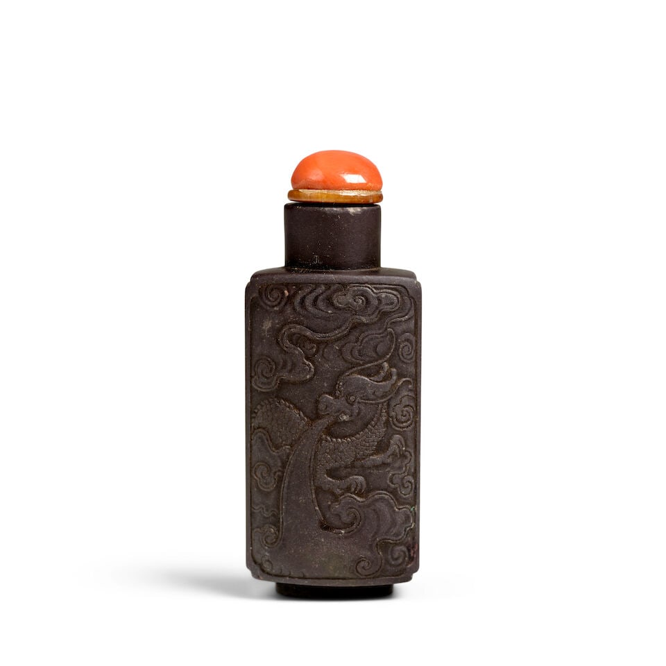 A RECTANGULAR PANELED DUAN INKSTONE 'LOW-RELIEF DRAGON-CARVED' SNUFF BOTTLE 1780-1860: A RECTANGULAR PANELED DUAN INKSTONE 'LOW-RELIEF DRAGON-CARVED' SNUFF BOTTLE 1780-1860 2 1/2in (6.3cm) high, stopper Footnotes: 1780-1860