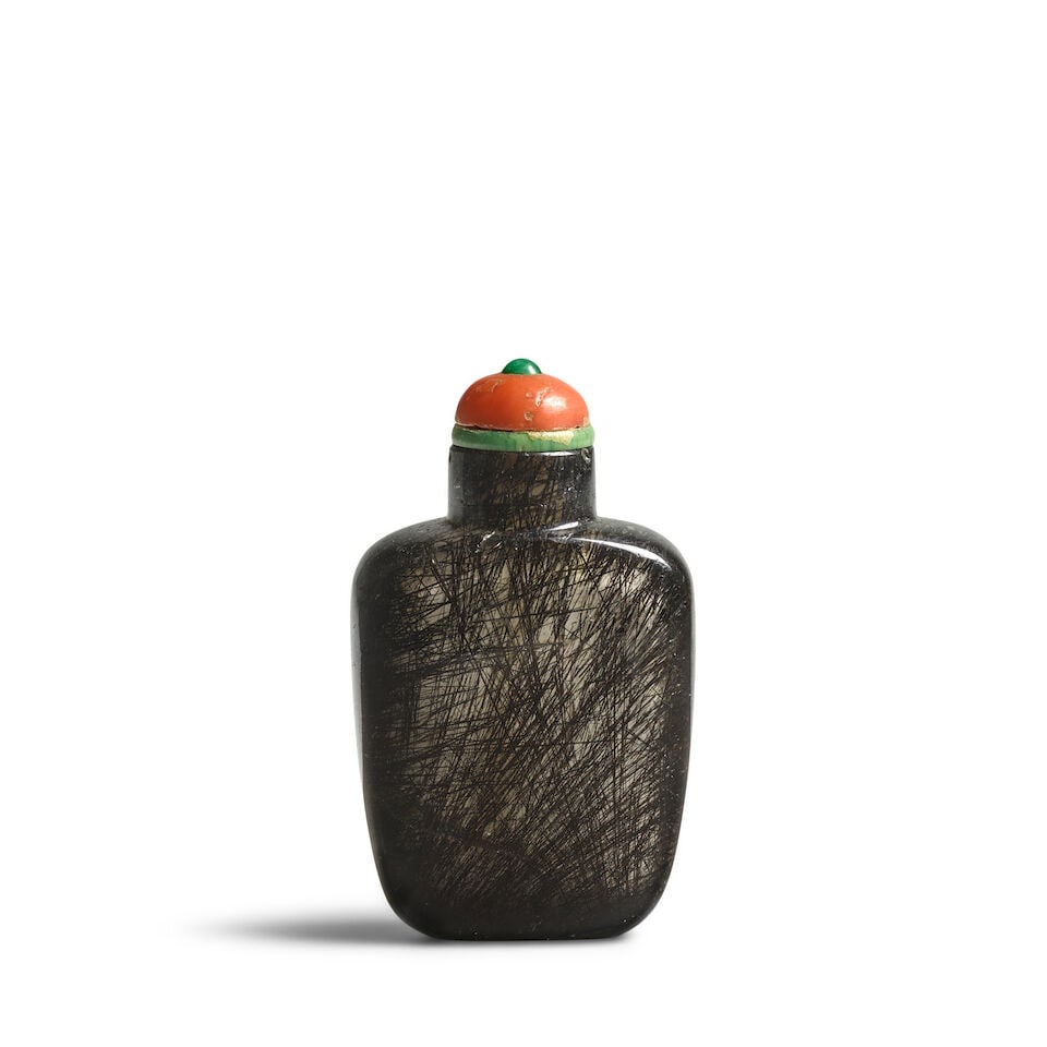 A SMALL, PLAIN TAPERING RECTANGULAR DENSE HAIR CRYSTAL SNUFF BOTTLE 1800-1900: A SMALL, PLAIN TAPERING RECTANGULAR DENSE HAIR CRYSTAL SNUFF BOTTLE 1800-1900 2 1/4in (5.8cm) high, stopper Footnotes: 1800-1900 素面髮晶鼻煙壺一件