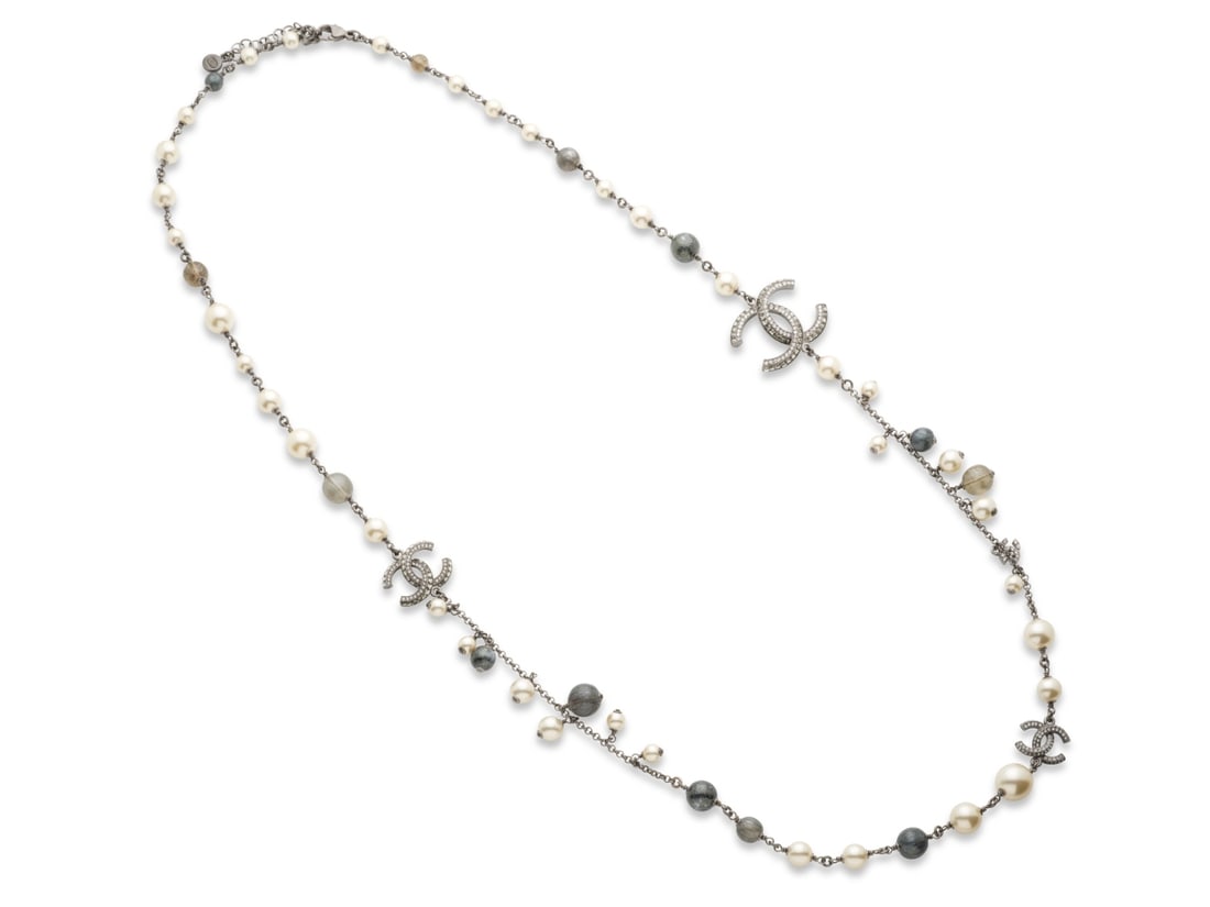 Chanel, collection Prêt à Porter Printemps/Eté 2011. Sautoir chaine de perles gri...: Chanel, collection Prêt à Porter Printemps/Eté 2011. Sautoir chaine de perles grises et blanches d'imitation. Chanel, Ready-to-Wear Spring/Summer 2011 collection. Long necklace with a c