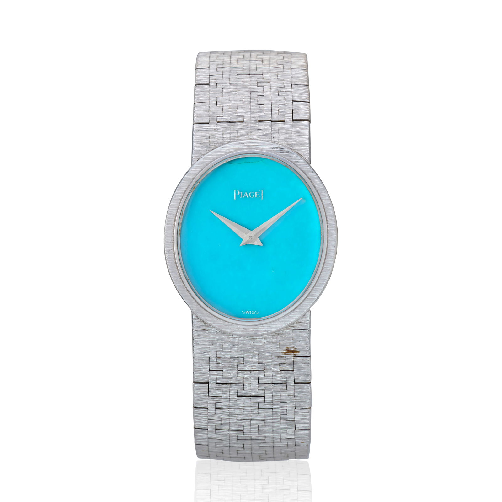 Piaget. A lady's 18K white gold manual wind bracelet watch with turquoise dial Ref: 9821 A6, Cir...: Piaget. A lady's 18K white gold manual wind bracelet watch with turquoise dial Reference: 9821 A6 Date: Circa 1985 Movement: Jewelled manual wind Dial: Turquoise, polished lance hands Case: Brushed an