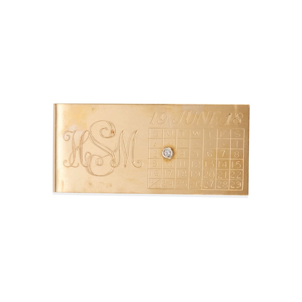 14K GOLD AND DIAMOND MONEY CLIP: 14K GOLD AND DIAMOND MONEY CLIP • 14k yellow and white gold • 1 round diamond weighing approximately 0.02 - 0.03 carat • Personal inscription and date • Measures 2 1/16 x