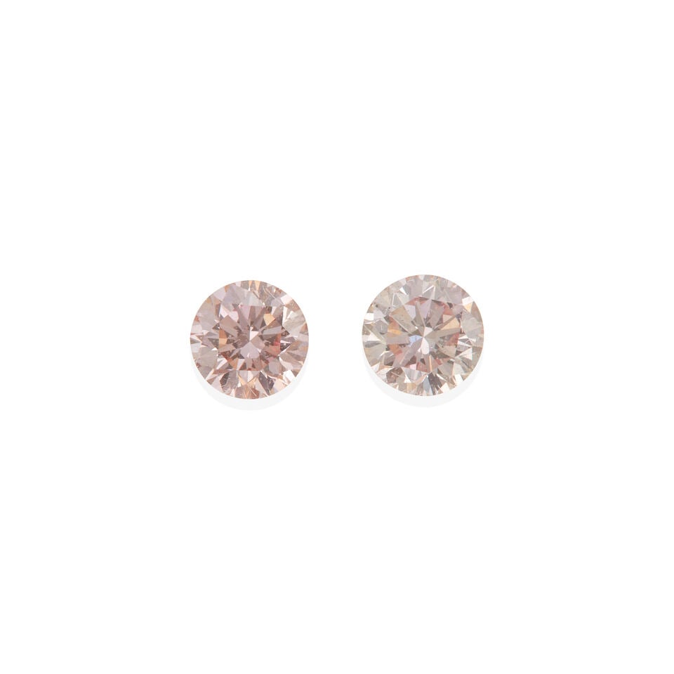 TWO LOOSE PINK DIAMONDS WITH ARGYLE PINK DIAMOND REPORTS: TWO LOOSE PINK DIAMONDS WITH ARGYLE PINK DIAMOND REPORTS • 2 loose round cut pink diamonds weighing 0.18 and 0.19 carat each • Encased in Plexiglass/acrylic • Accompanied by Argyle P