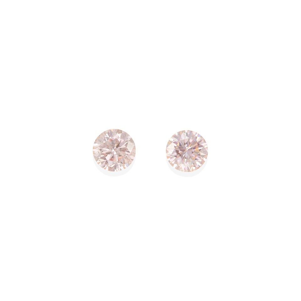 TWO LOOSE PINK DIAMONDS WITH ARGYLE PINK DIAMOND REPORT: TWO LOOSE PINK DIAMONDS WITH ARGYLE PINK DIAMOND REPORT • 2 loose round cut pink diamonds weighing 0.15 carat each • Encased in Plexiglass/acrylic • Accompanied by Argyle Pink Diamon
