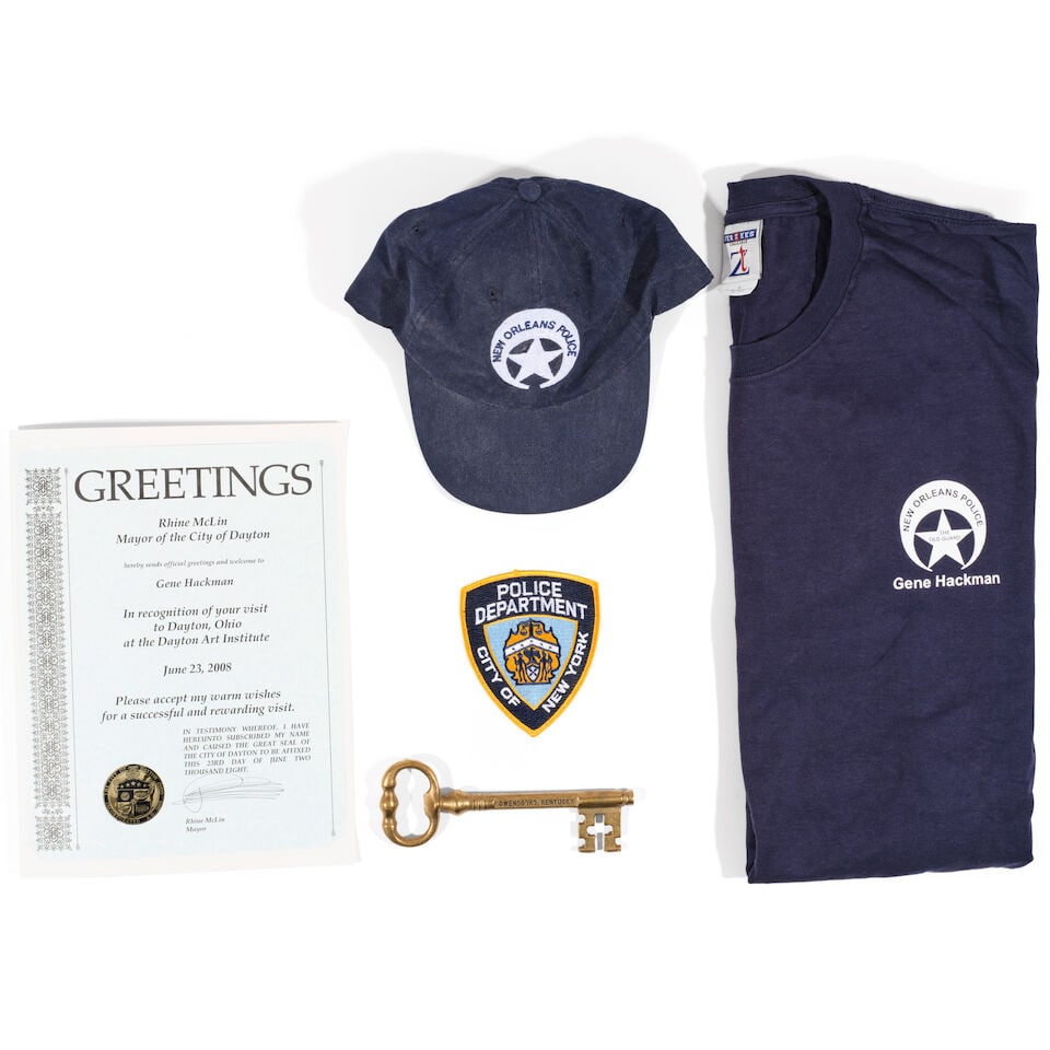 Gene Hackman: A Group of Honorary Material, Qty.: Gene Hackman: A Group of Honorary Material, Comprising two t-shirts and a canvas baseball hat, the shirts inscribed NEW ORLEANS POLICE / THE / OLD GUARD / Gene Hackman and the hat inscribed NEW