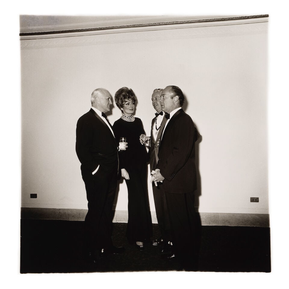 Diane Arbus (1923-1971); Four People at a Gallery Opening, N.Y.C.;: Diane Arbus (1923-1971) Four People at a Gallery Opening, N.Y.C., 1968 Gelatin silver print, printed posthumously by Neil Selkirk; the 'A Diane Arbus photograph' stamp, signed by Doon Arbus and with t