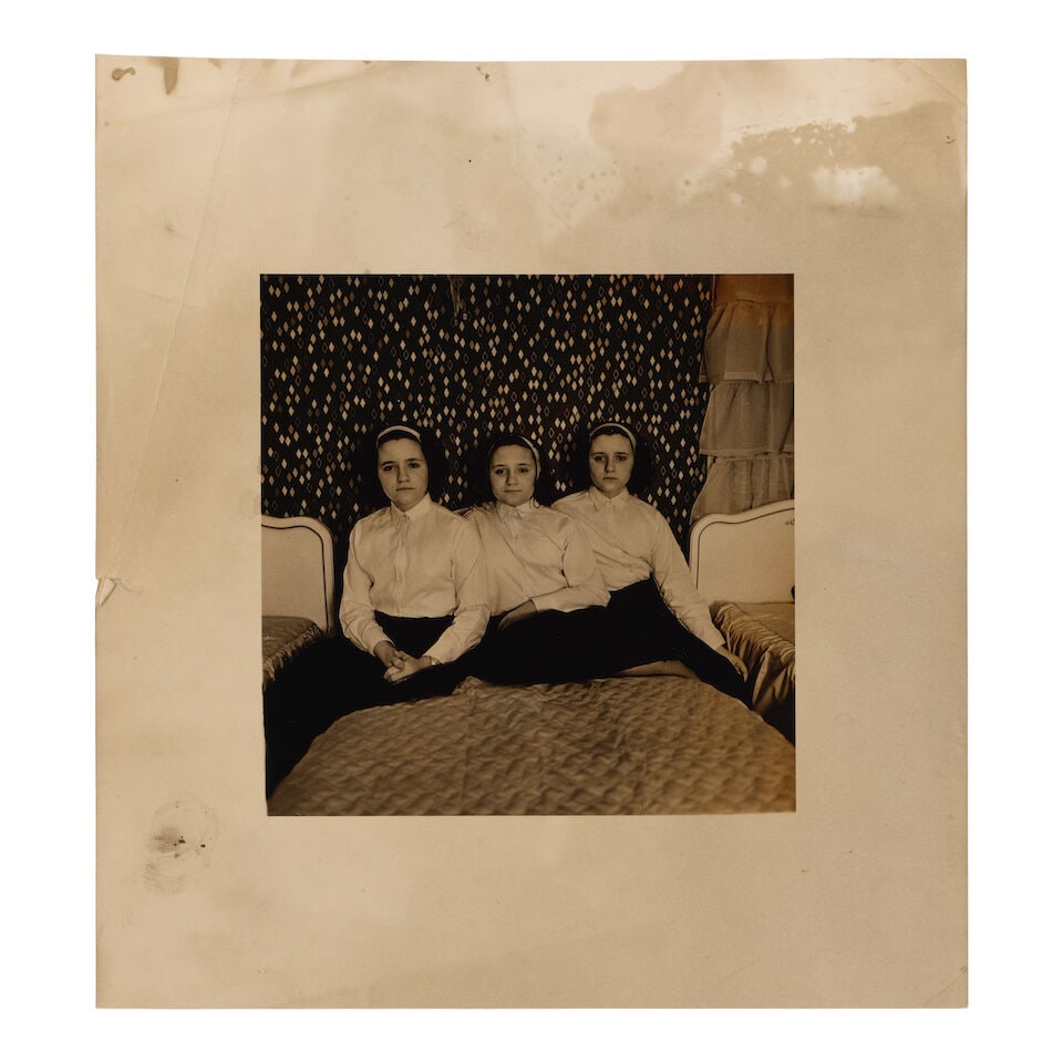 After Diane Arbus (1923-1971); Triplets in their bedroom, N.J.;: After Diane Arbus (1923-1971) Triplets in their bedroom, N.J., 1963 Gelatin silver print, print date and printer unknown. 5 x 4 7/8 in. (12.7 x 12.4 cm.) sheet 8 3/8 x 8 in. (21.3 x 20.3 cm.) Footnote